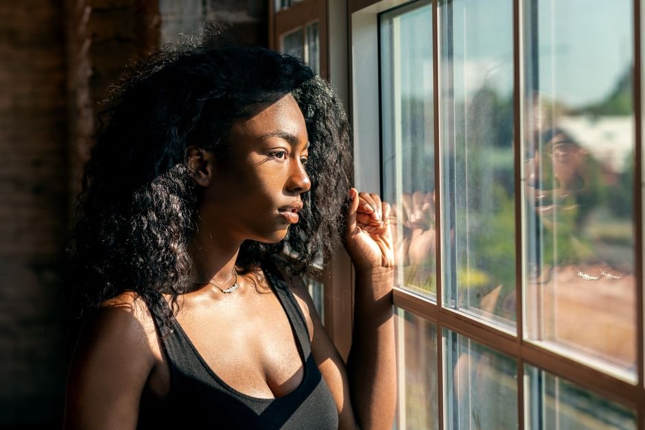 Person sitting by a window in natural light