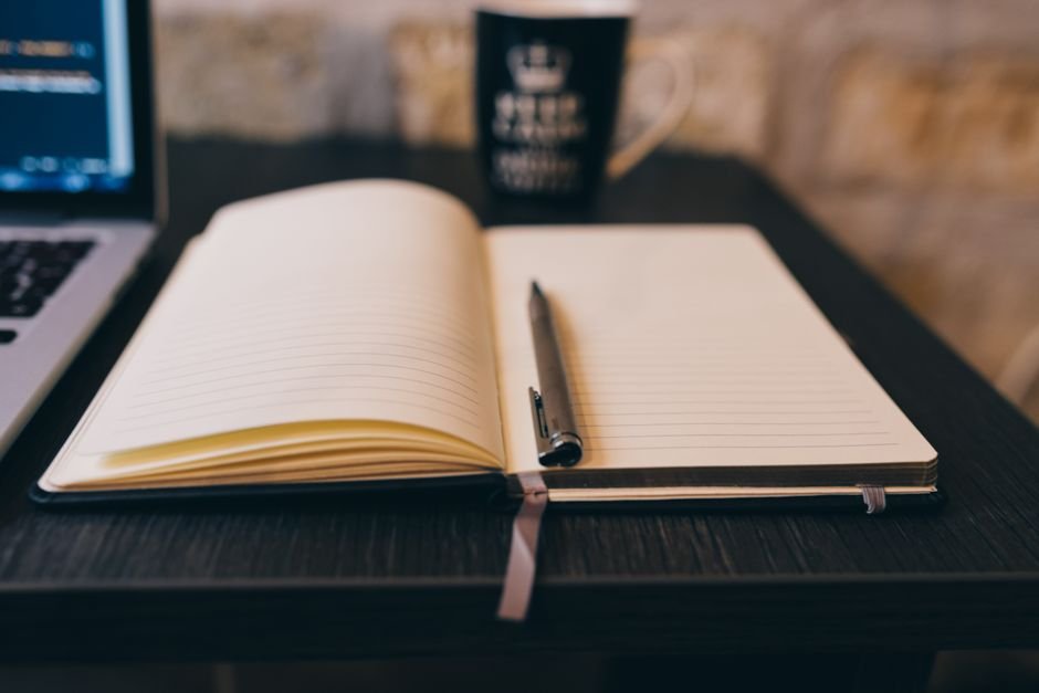 Writing in a journal at a table